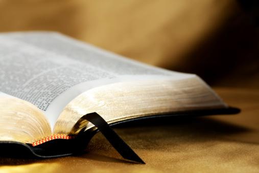 Image Of A Open Bible with a Gold Texture Background